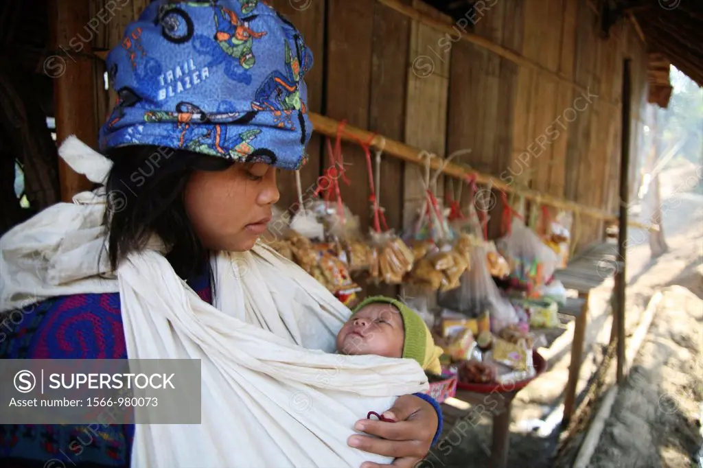 A young girl cradles a baby in Mae Sot refugee camp Around 130,000 Burmese refugees have settled in Thailand due to opression in their homeland of Mya...