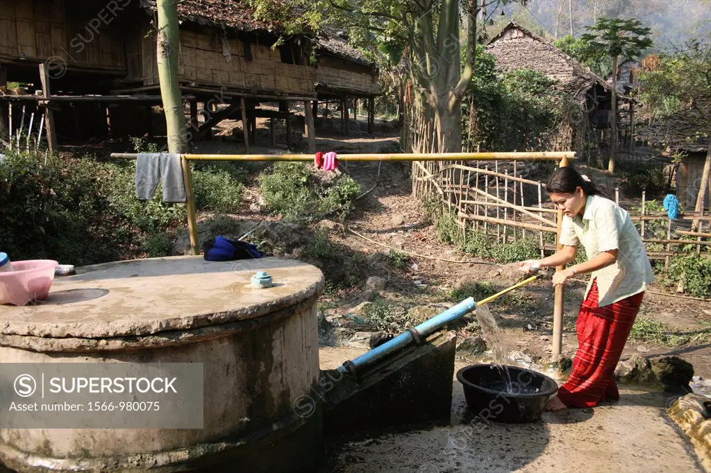 A woman gets water from a village pump in Mae Sot refugee camp Around 130,000 Burmese refugees have settled in Thailand due to opression in their home...