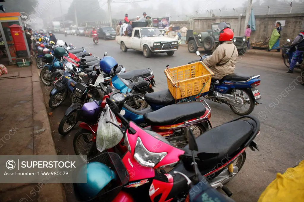 Mopeds and motorcyles parked near the market in Mae Sot Around 130,000 Burmese refugees have settled in Thailand due to opression in their homeland of...