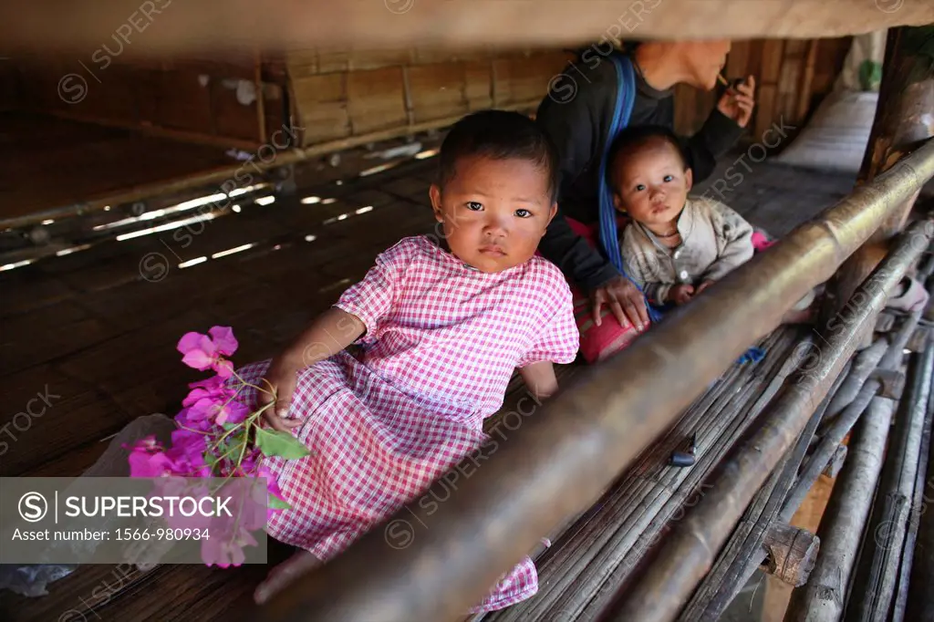Children in a hut in the displaced persons camp near the border with Thailand In Myanmar Burma, thousands of people have settled near the border as a ...