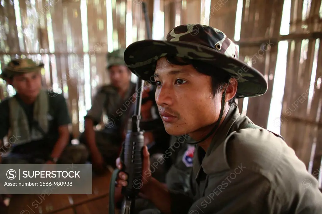 Closeup of a young KNLA soldier sitting in a hut In Myanmar Burma, thousands of people have settled near the border as a result of oppression in their...