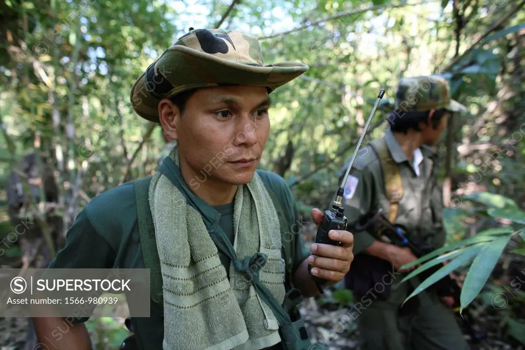 Closeup of KNLA soldier with a radio in the jungle near Thailand In Myanmar Burma, thousands of people have settled near the border as a result of opp...