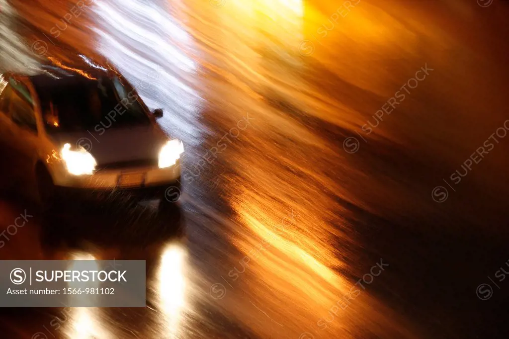 fast car driving in heavy rain at night in town