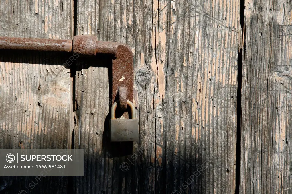 old wooden door closed with padlock