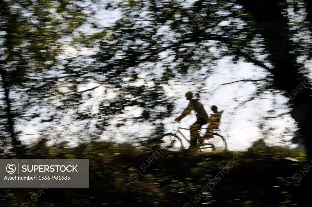person riding fast bike on rural lane countryside