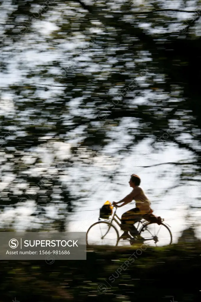 person riding fast bike on rural lane countryside
