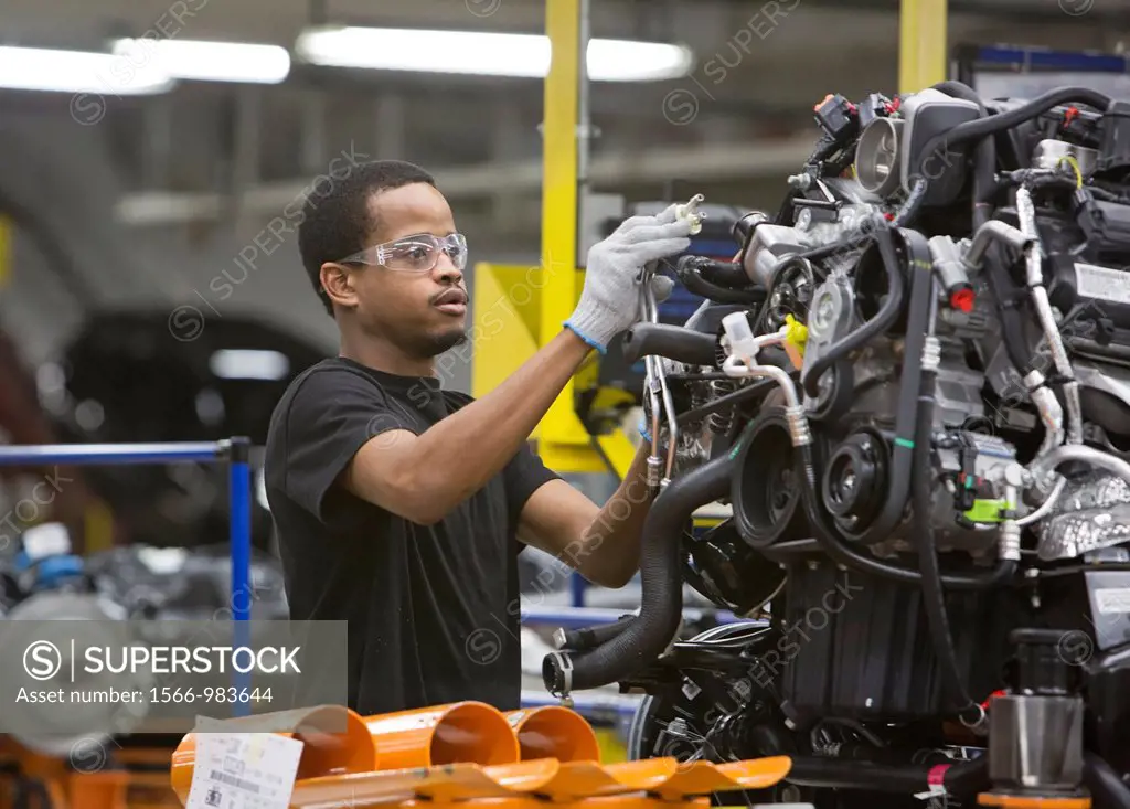 Detroit, Michigan - A worker adds parts to an engine at Chrysler´s Jefferson North Assembly Plant