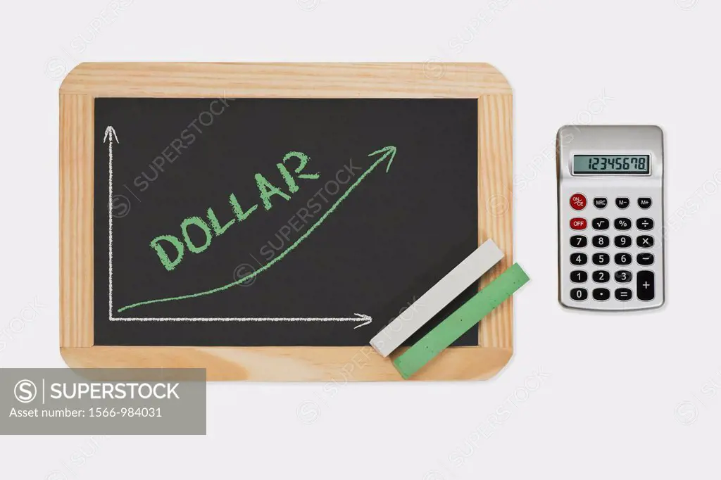 Detail photo of a chalkboard. A chart with an increasing curve on this. On the chalkboard is the word Dollar written. Green and white chalk lies in a ...