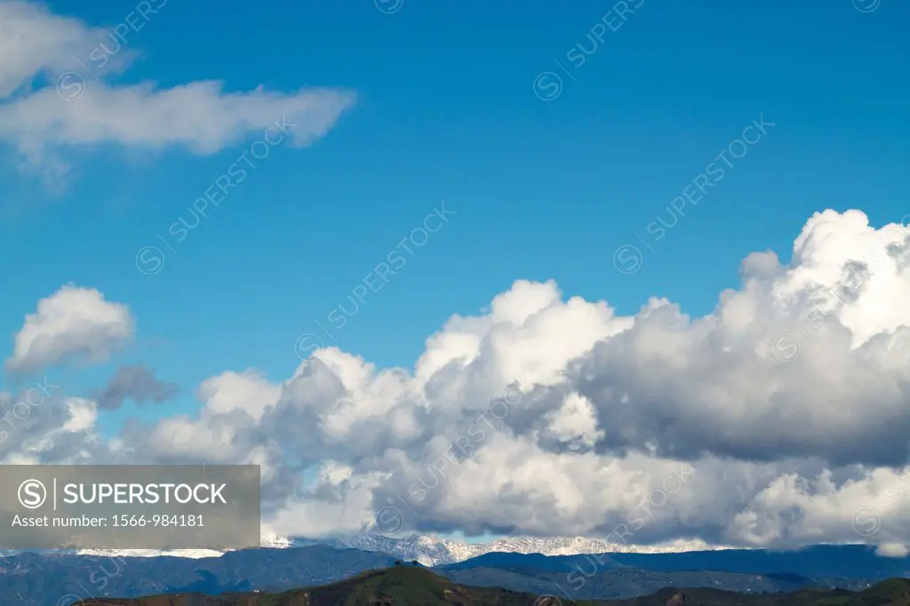 White puffy clouds over Two Trees