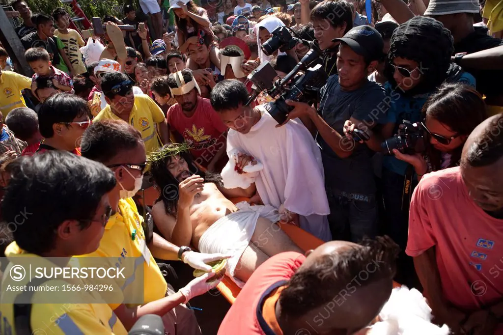 Cebu City, Philippines, Good-Friday, 6 April 2012: Gilbert Bargayo, being nailed to the cross for the 17th Good Friday, with six-inch nails, in Barang...