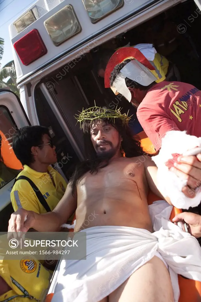 Cebu City, Philippines, Good-Friday, 6 April 2012: Gilbert Bargayo, being nailed to the cross for the 17th Good Friday, with six-inch nails, in Barang...