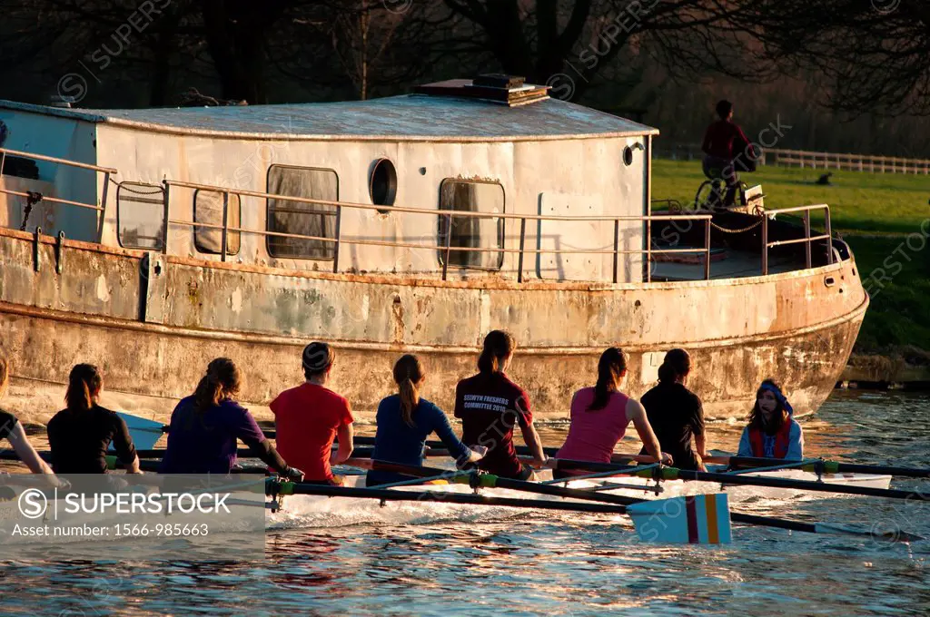 Rowers at sunset on river Cam near Cambridge, England