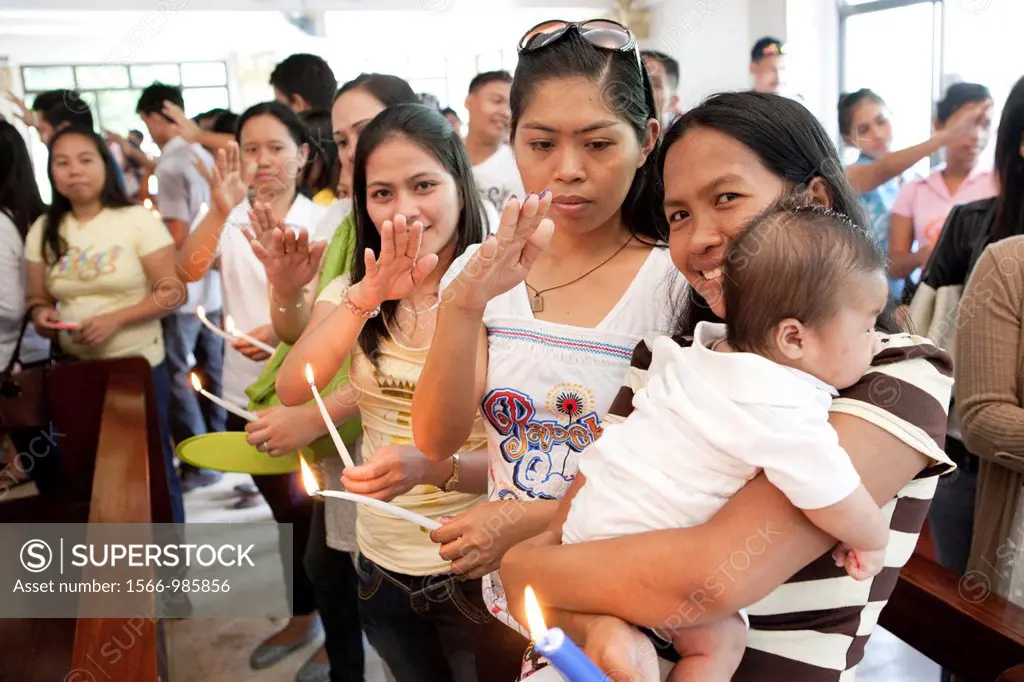 Lapu-Lapu City, Philippines, 26/02/2012: 200-300 babies being baptised in a single 3 hour ceremony at Mactan Air Base Chapel
