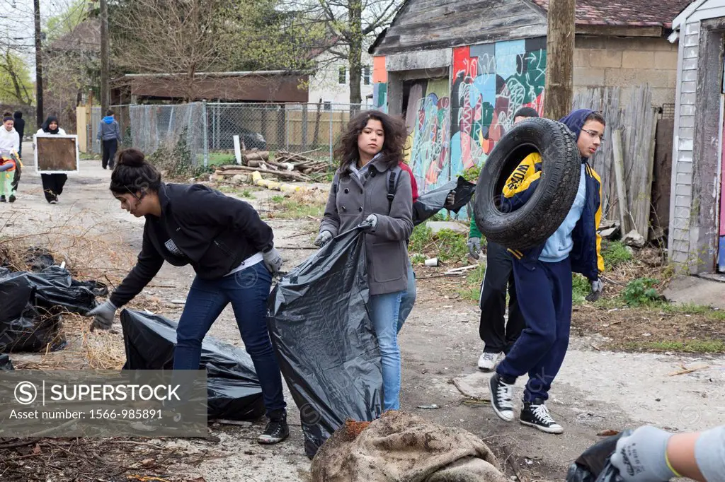 Detroit, Michigan - High school and college student volunteers clean trash from an alley