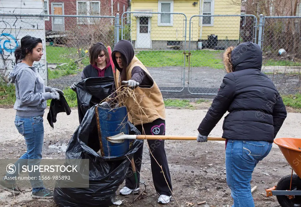 Detroit, Michigan - High school and college student volunteers clean trash from an alley