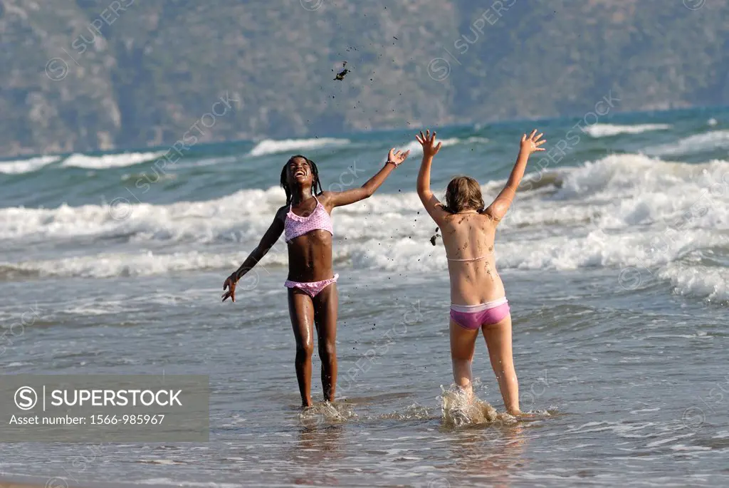 children playing in the waves of the Iztuzu beach, Dalyan, Turkey, Eurasia