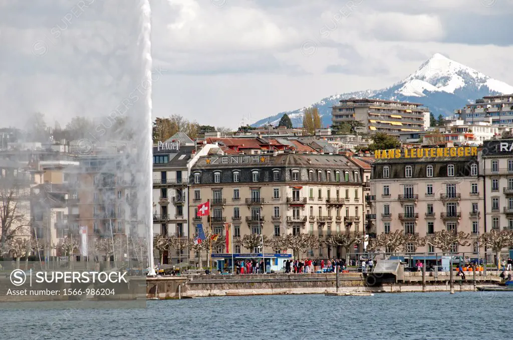 Cityscape of town of Geneva., Switzerland, Europe, with famous fountain Jet d´Eau on Geneva Lake in front and Alps in background