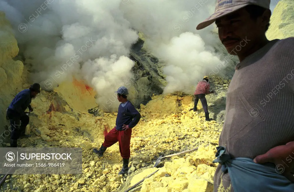 Men working inside the live volcano of Kawah Ijen, in East Java, Indonesia, one fo the last places in the world where people mine sulfur by hand, carr...