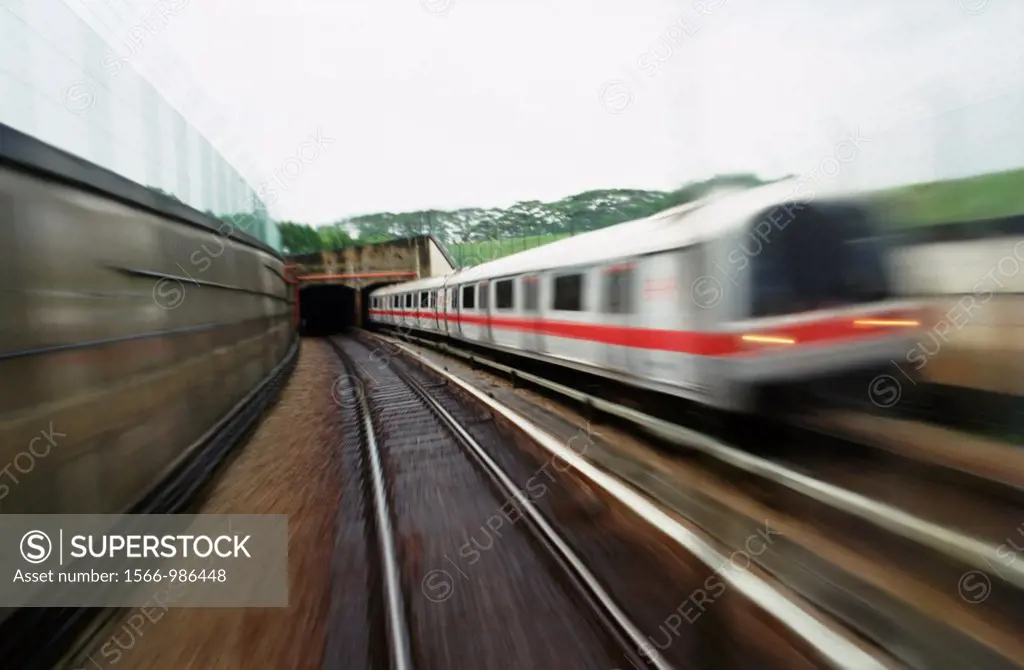 The MRT or subway of Singapore - a train emerges from the underground tunnel