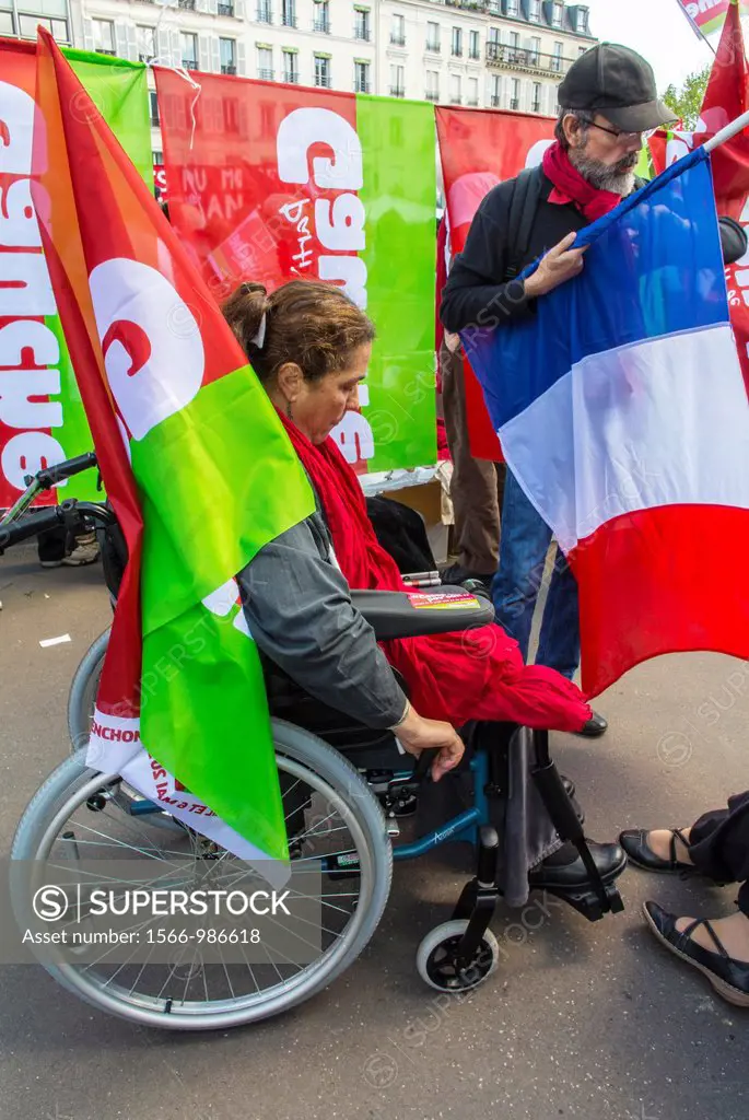 Paris, France, French Handicapped Woman in Wheelchair, Outside on Street, With Extreme Leftist Political party Flags, During Annual May Day Events,