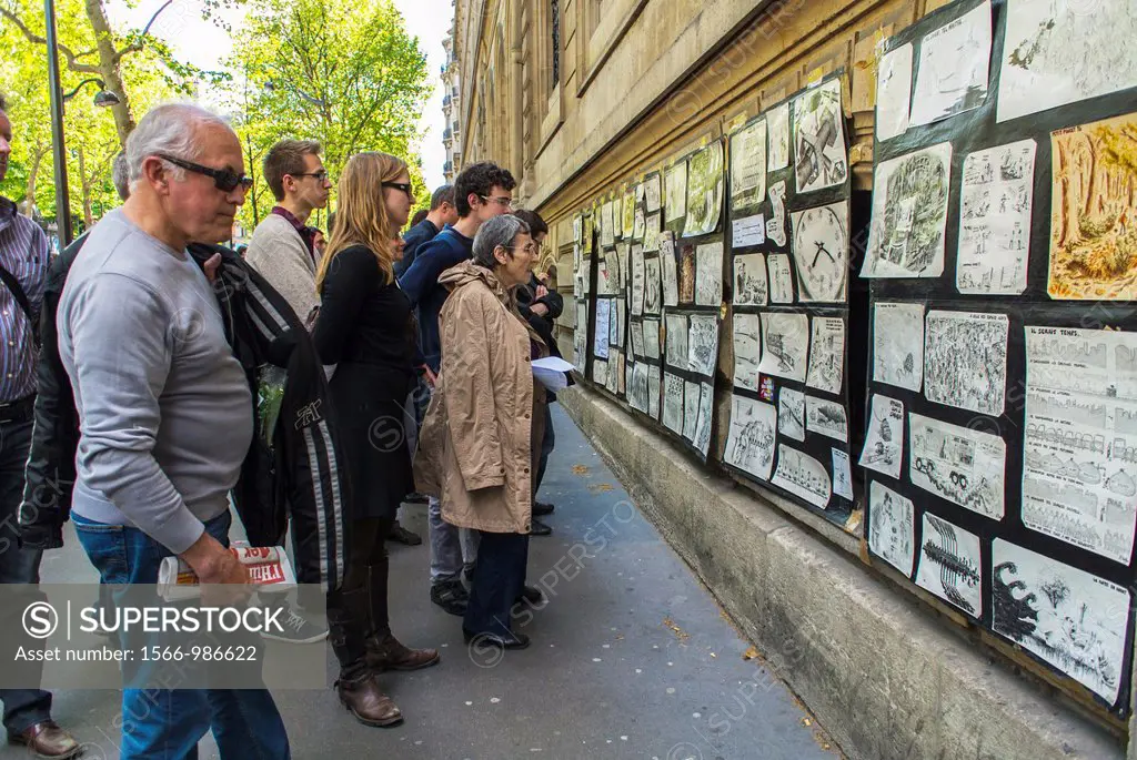 Paris, France, French Public Looking at Political Art display on Wall Outside on Street During Annual May Day Events,