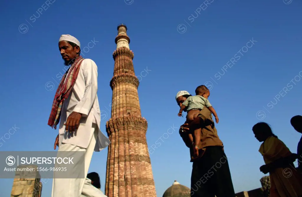 Pilgrims at Qutab Minar outside of Delhi   Qutab Minar, the 239ft sandstone tower is an Indo-Islamic architectural wonder of ancient India  This magni...