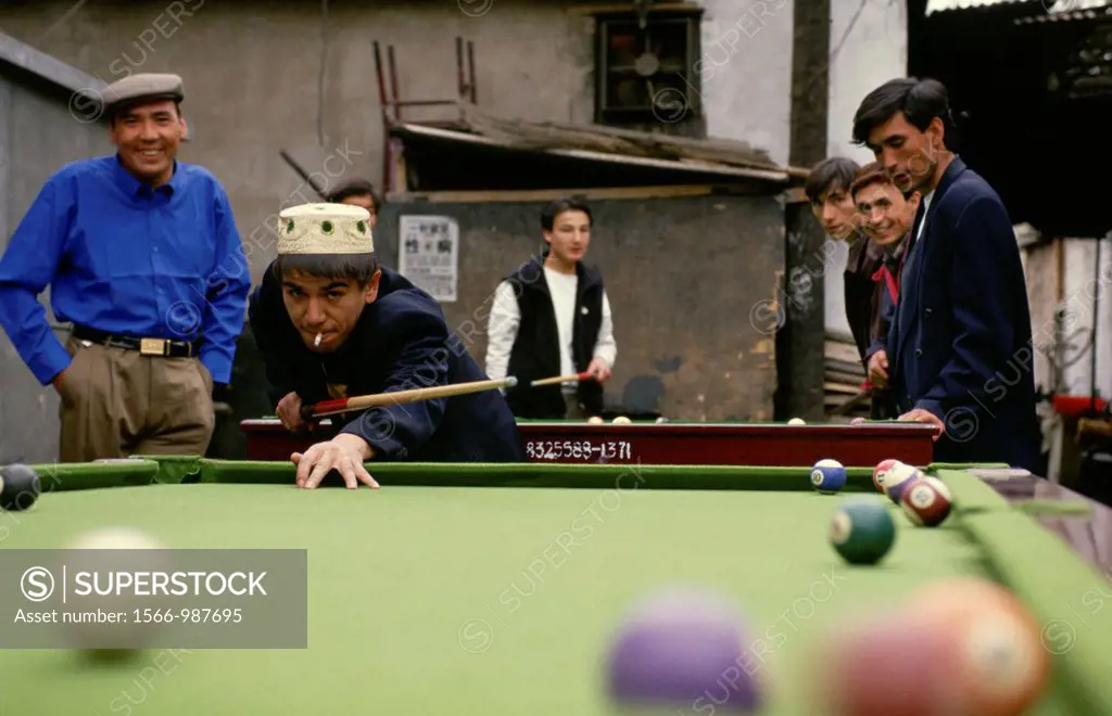 Uygur muslims in Beijing, play a game of pool or billiards in the back alley of the old Uygur community in the heart of the city