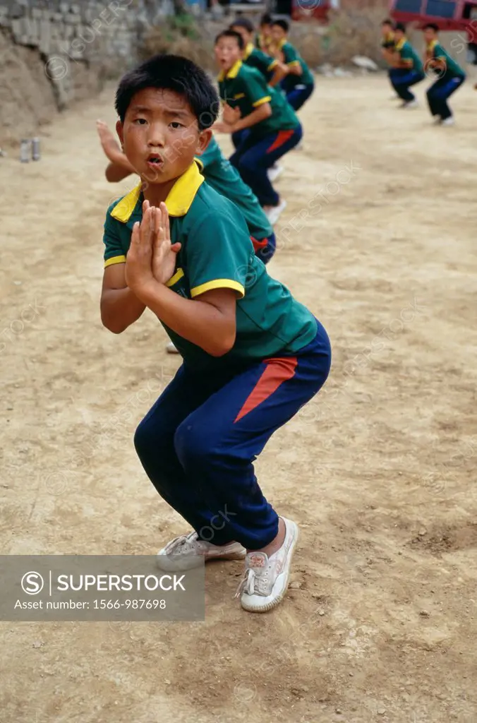 Chinese students at the Ta Gou Academy, the largest martial arts school in the world, practice punching and kicking The students practice Shaolin kung...