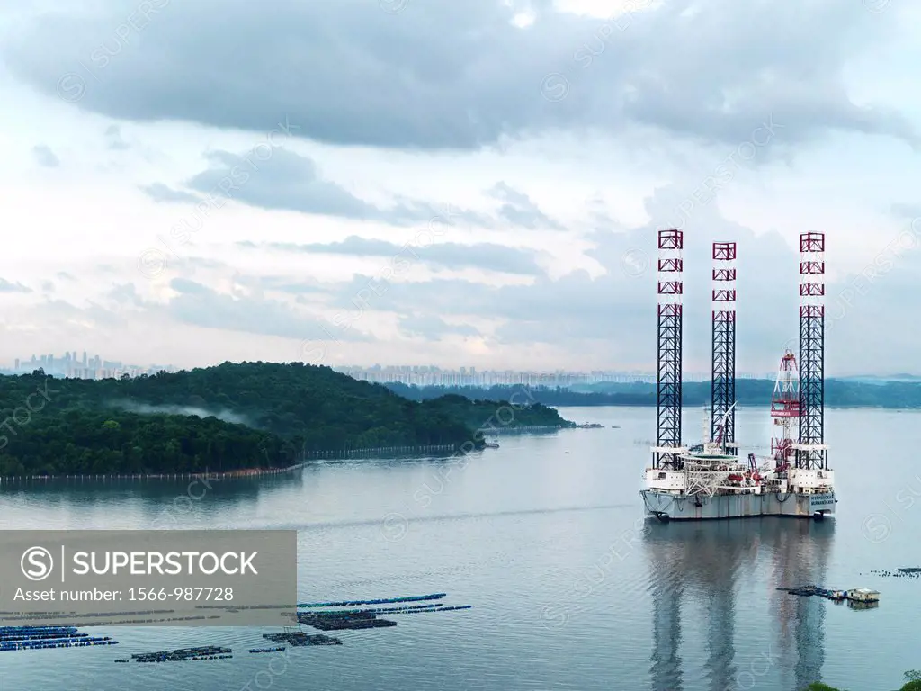 A scenic view of an oil rig located along side a fish farm off of Johor´s coast