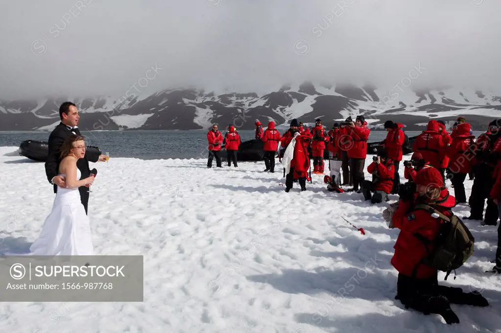 Couple celebrating their wedding on ice at -10°C, Deception Island, South Shetland Islands, Antarctica
