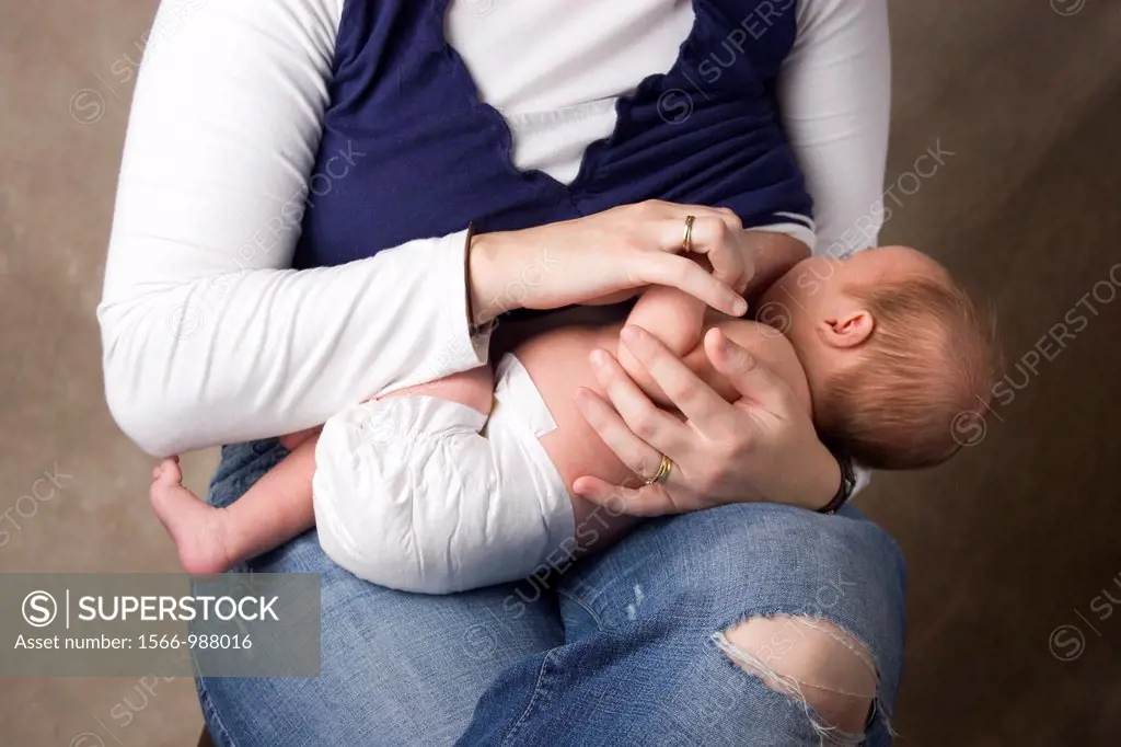 A woman holds her baby as she breastfeeds