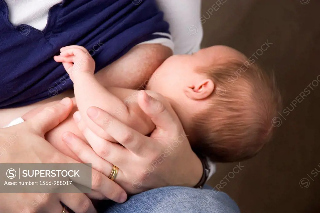 A woman holds her baby as she breastfeeds