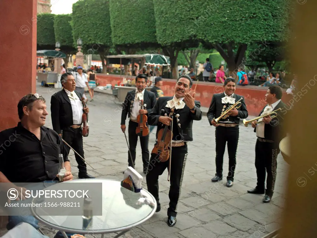 Band members of Mariachi band Guanajuatense play for tourists in the main plaza - El Jardin