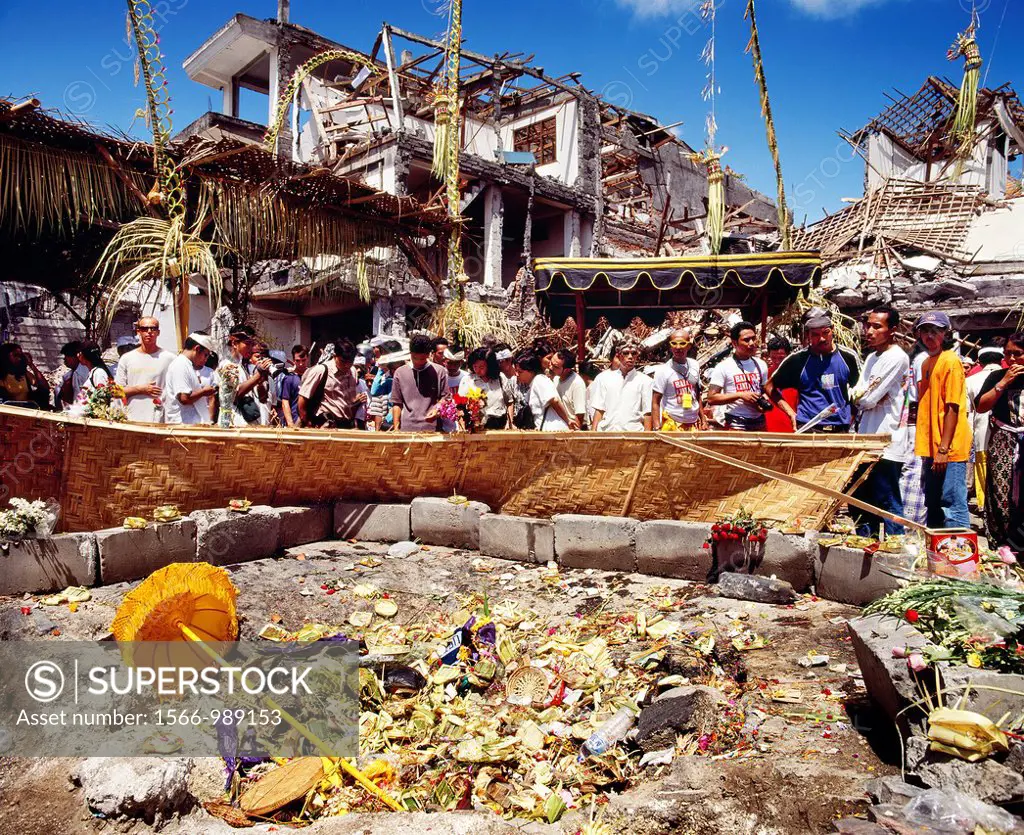 Locals praying and giving offerings at the ground zero site of the 12 October 2002 Bali bombings in the tourtist district of Kuta, Bali