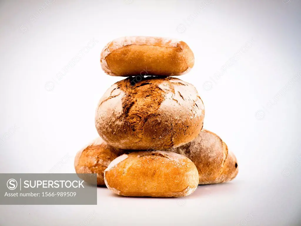 Loaves of bread, one over the other, on white background.
