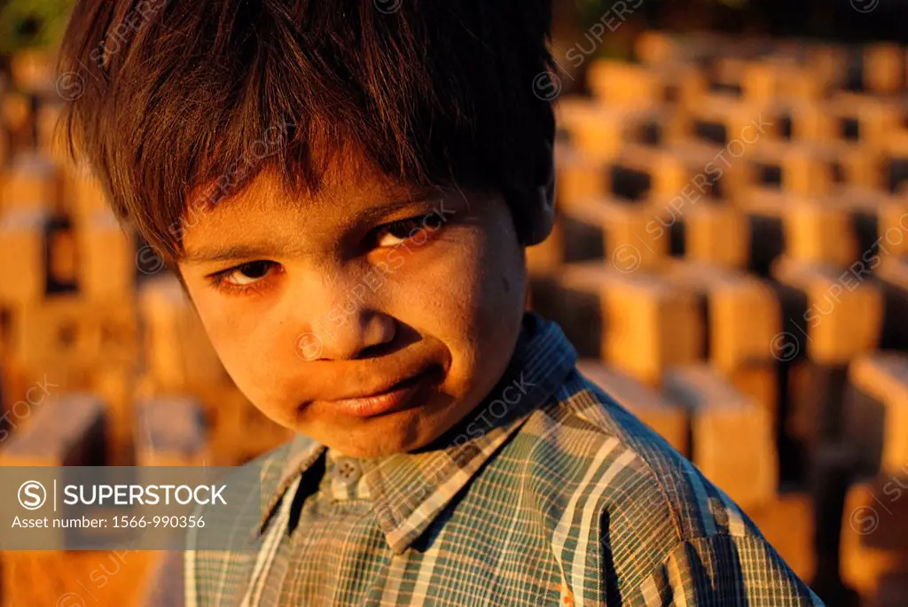 Boy working in a brickyard. Kachchh area, Gujarat, India.