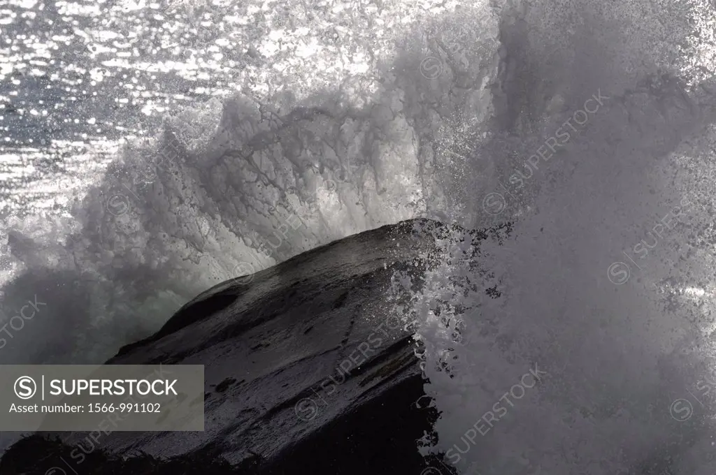 Wave breaking on a large rock. North Atlantic, Unstad, Vestvågøy, Lofoten, Nordland, Norway, Scandinavia, Europe