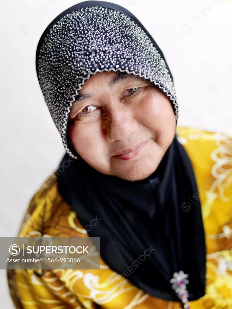 A portrait of a elderly woman wearing an embellished headscarf taken in Johor, Malaysia.