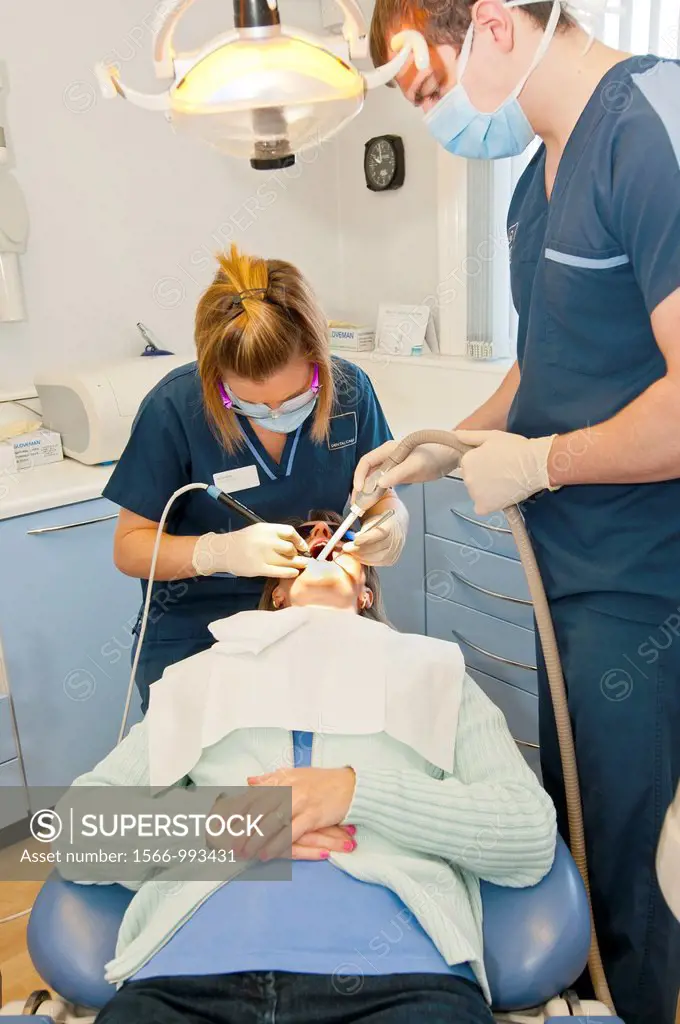 dental hygenist cleaning teeth