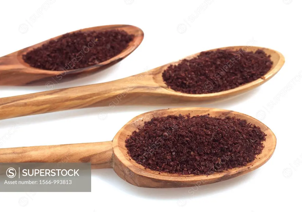 Sumac Powder, Spice in Spoons against White Background