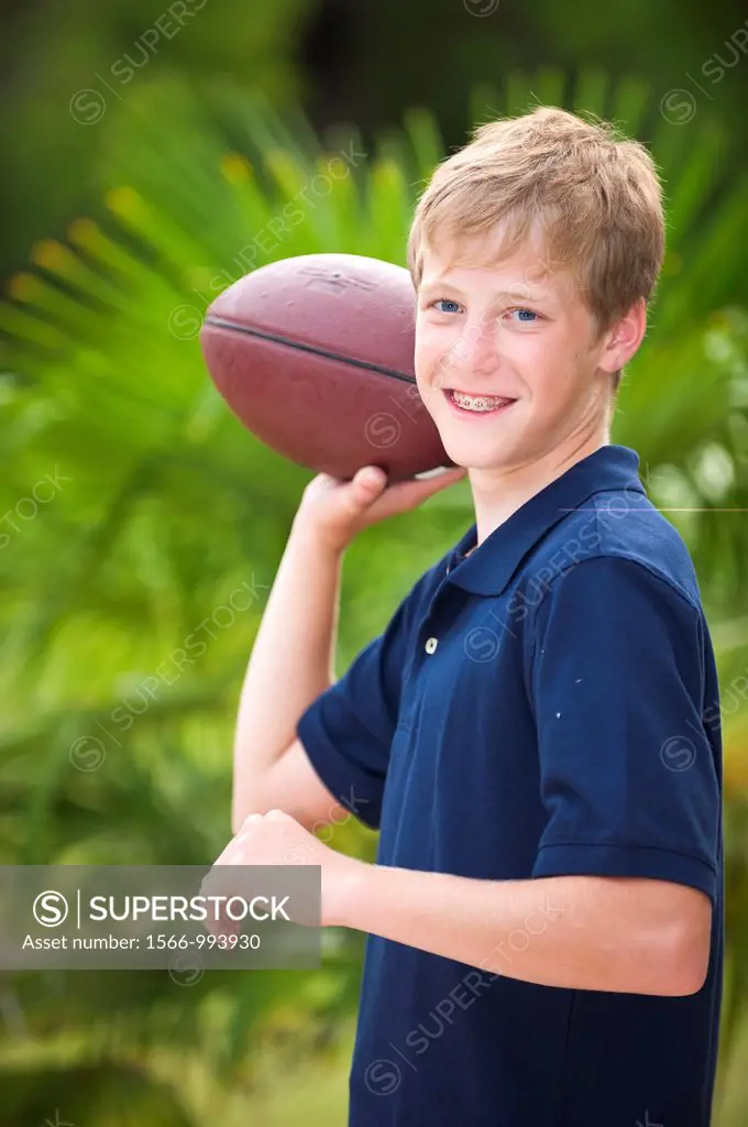 Young boy with american football