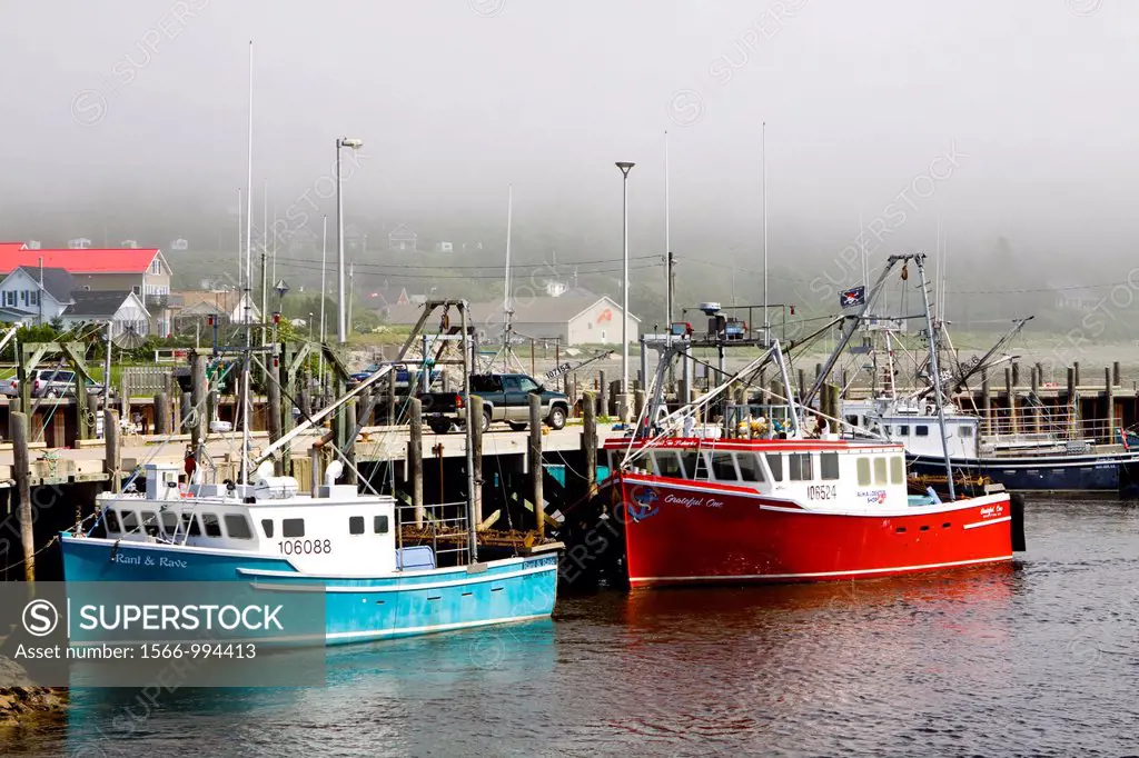 Lobster boats sitting on the seabed  Bay of Fundy, Alma, New Brunswick,is known for having the highest tidal range in the world  Specifically in Alma ...