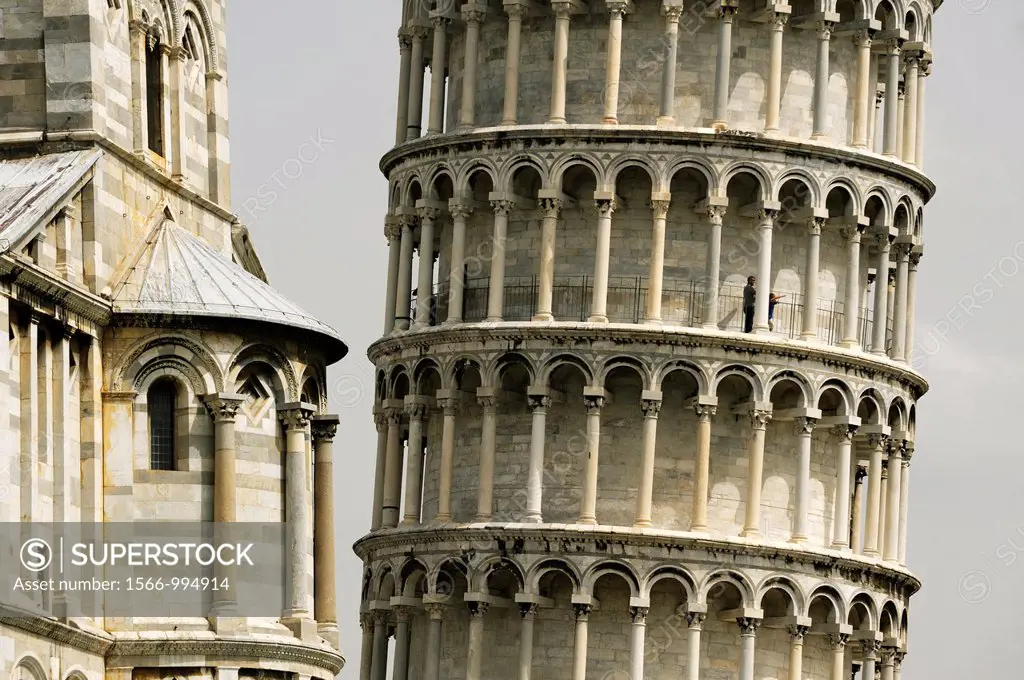 The Leaning Tower of Pisa angles away from the south transept of the Duomo in the Piazza dei Miracoli, Pisa, Tuscany, Italy