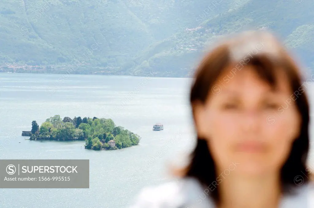 Close up on a woman and brissago islands in the background with a passenger ship