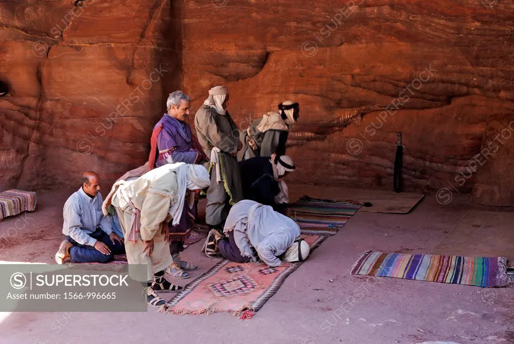 men praying in a cave of Petra, Jordan, Middle East, Asia