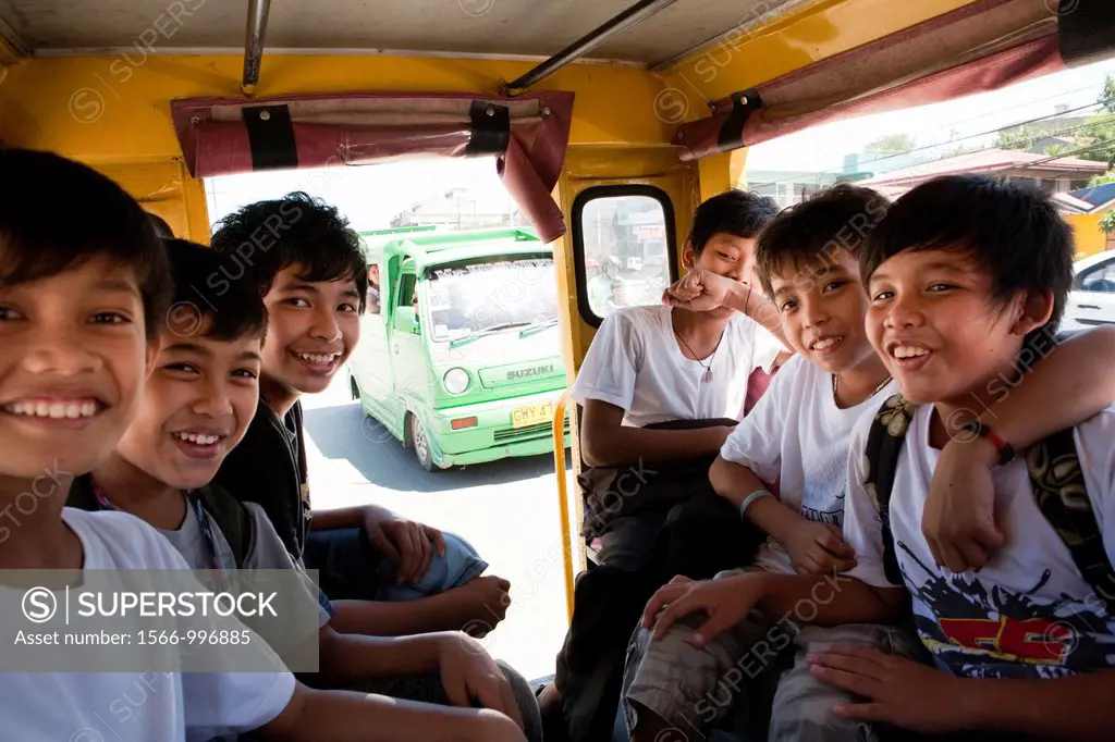 Filipino boys riding a jeepney on their way home from school  Lapu-Lapu City, Metro Cebu, Mactan Island, Visayas, Philippines