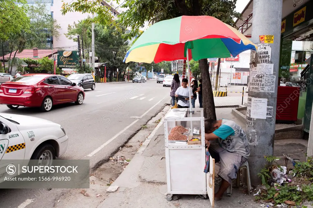 A sleeping street vendor, selling peanuts  Cebu City, Cebu, Visayas, Philippines