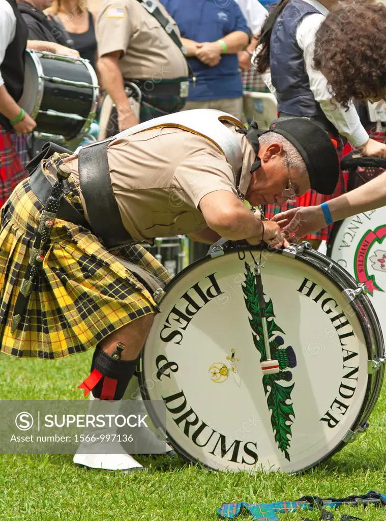 Drummer and piper pratcise at Scottish Highland Festival, Blairsville Georgia USA adjusts his drum