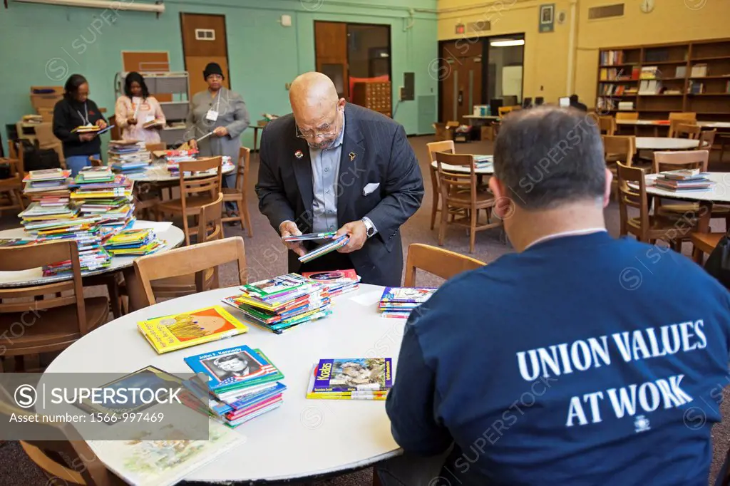 Detroit, Michigan - Foster Stringer of the American Federation of Teachers joins other union volunteers in sorting books in the library at Sampson-Web...