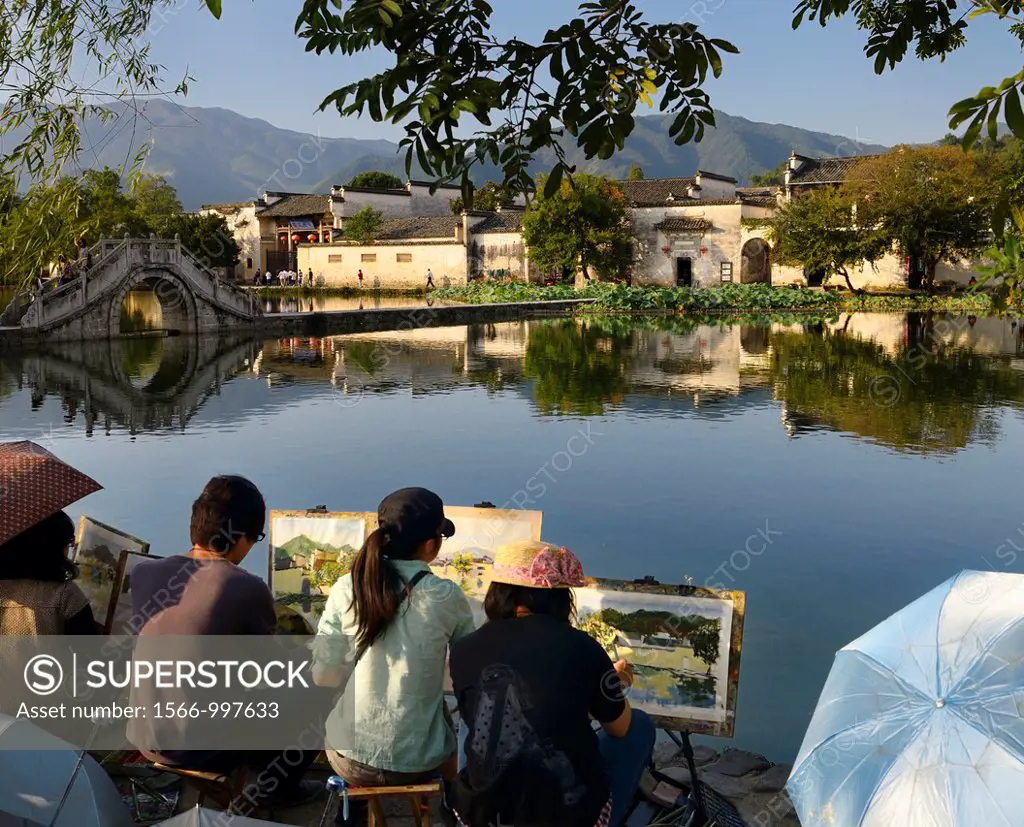 Group of student painters at South Lake in Hongcun World Heritage Site Anhui Province China